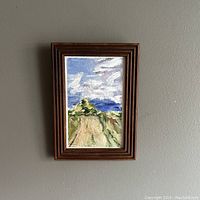 Front view of the framed landscape oil painting showing the artwork and frame.