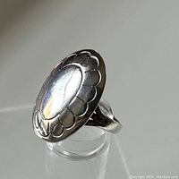 Front angled view of the sterling silver Navajo ring showing the oval stamped design