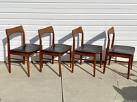 Set of four chairs in a row, front view showing frames and seats