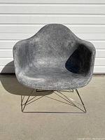 Front view of chair showing shaped fiberglass shell seated on wire base.