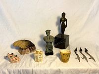 Full lot overview showing all items including statues, letter openers, pottery, and snuff containers.