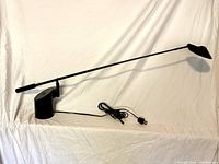 Full view of lamp showing base, arm and shade