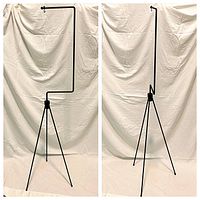 Front and side view of the black metal birdcage stand showing tripod legs and angled hanging arm with knob and hook.