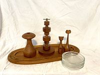 Full view of all items arranged on the oval tray with clear glass dishes visible on nut server.