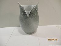 Front view of the gray and white art glass owl-shaped vase showing the detailed owl face and pointed ear tufts.