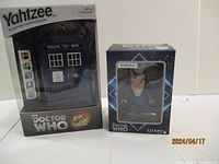 Photo showing the Doctor Who TARDIS-shaped Yahtzee game and the 12th Doctor Pop Vinyl figure in original packaging.