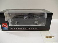 Side view of the 1999 Dodge Viper GTS black die cast model in original AMT box, showing detailed sculpting and packaging.