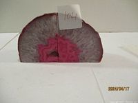 Front view of two matching pink geode stone bookends showing the crystalline interior and natural exterior surfaces.