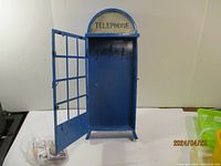 Front view of blue metal key box with windowed door open showing interior hooks, measuring approx 20 x 8 x 2.5 inches.