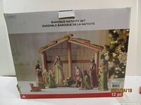Box front photo showing full baroque nativity set with stable and figurines.