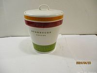 Front view of the Starbucks cookie jar showing logo and colored bands.