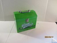 Front view of the green metal Steam Whistle lunch pail showing logo and latch.