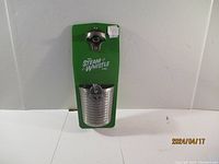 Photo of new Steam Whistle magnetic bottle opener with attached cap catcher on green backing card.
