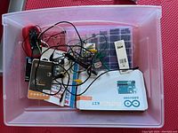 Top view of first drawer with Arduino Starter Kit box, assorted wires, electronic components in plastic organizer