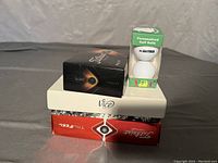 Photo showing stacked boxes of Titleist Pro V1, Vice and Titleist TruFeel golf balls along with a small package of 2 personalized balls.