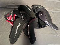 Assorted black Pinemeadow golf club covers with mesh and fabric construction, some including numbers 7 and 9.