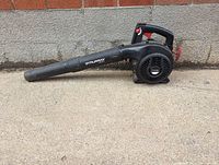 Black Murray Select leaf blower with tubular nozzle side view on concrete and wall.