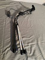 Two LED light bars with red and blue LED diodes mounted on adjustable arms with a clamp for attachment.