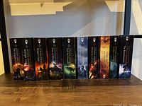 Front view of the complete set of Steven Erikson books lined up side by side showing spine cover art and titles