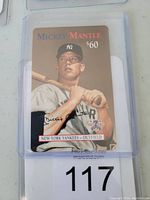 Front of the 1997 Mickey Mantle phone card showing image, value, and branding in a protective plastic case.