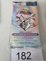 Front view of one sealed pack of 2020-21 SP Hockey cards featuring a hockey player in a Rangers jersey and promotional text for autograph and jersey cards.