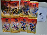 Four unopened promo packs from 1995 Fleer Ultra X-Men series arranged on a surface, showing varied X-Men character artwork on gold foil packs.