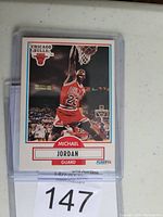 Front of 1990 Fleer Michael Jordan basketball card showing player mid-dunk with visible card printing errors.