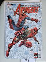 Front cover of Avengers #51 comic book showing Spider-Man and Deadpool on web background.