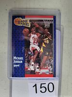 Front of the 1991 Fleer Michael Jordan basketball card showing Jordan mid-play and League Leaders design.
