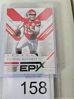 Front of Patrick Mahomes II football insert trading card in protective plastic sleeve with label number 158.