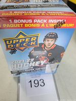 Front view of the sealed 2021-22 Upper Deck Series One Hockey blaster box showing main branding, player image, and bonus pack mention.