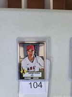Front of Shohei Ohtani baseball card in protective plastic sleeve, showing player image, Los Angeles Angels uniform, team logo, card number 104.
