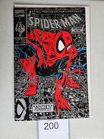 Front cover image of Spider-Man #1 black and silver variant comic book showing Spider-Man crouching on a web with the title in bold letters and red color details.