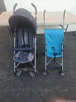 Two folding baby carriages side by side showing overall condition and design