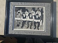 Full view of the framed black and white group portrait measuring 12 x 15 1/4 inches