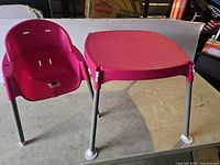 Matching pink child's plastic table with metal legs.