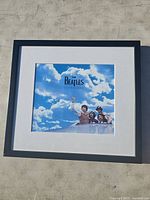 Front view of the framed Beatles Anthology print with sky and band members.