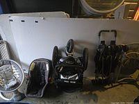 Baby car seat, upside down baby swing frame, folded twin stroller in one photo showing all items folded for transport