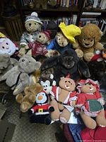 Overhead view showing large assortment of stuffed bears, gorilla, lion, penguin, dog, and other animals including dressed teddy bears.