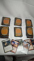 Six stacks of Magic the Gathering cards with backs facing up, plus several cards laid out showing card faces and text in Korean language