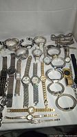 Overview of 30 vintage silver tone metal wristwatches arranged flat showing various styles, bracelet types, and watch faces