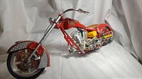 Side view of the red and chrome detailed Orange County Choppers fire department tribute bike scale model.