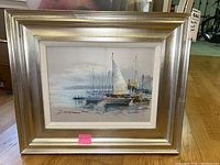 Frontal photo of the framed sailboat painting showing the entire artwork and frame.
