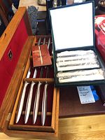 Gerber 11-piece carving set in wooden box displayed with lid open, showing knives with smooth handles on red fabric interior.