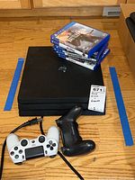 Overview showing console, two controllers and game cases