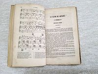 Open page showing text titled 'Le Clerc De Notaire' in French with printed musical notation on left page, indicating contents include legal or notarial text and music.