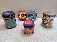Front view of all five assorted Planters Peanuts collectible tins showing different sizes and designs.