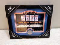 Framed New York Islanders commemorative hockey team coin in original Highland Mint packaging, showing full front with black protective corners on corners of the box.