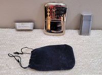 Front view of Sportsman hand warmer, Ronson Jet Lite lighter, Sportsman charcoal insert, and black pouch