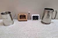 Full lot showing two pewter beer steins, collectible polar bear spoon, boxed soapstone chilling stones with holder